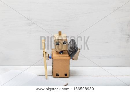 Robot holding a pen writing in diaries and talking on the phone. Artificial Intelligence