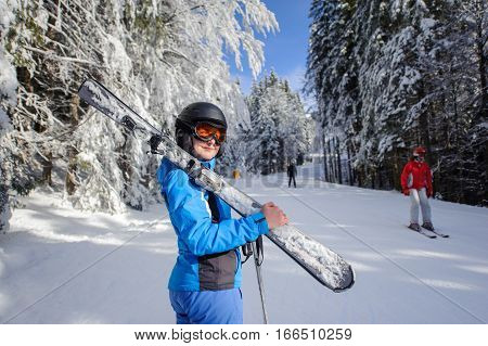 Happy Woman Skier On A Ski Slope In The Forest