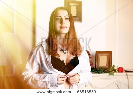 Sexy woman unbuttoned blouse revealing her bra.