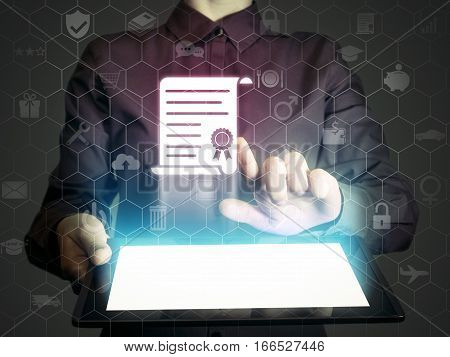 Concept of online learning. Person touches to certificate icon (diploma). She holds tablet pc that contains a many different online services.