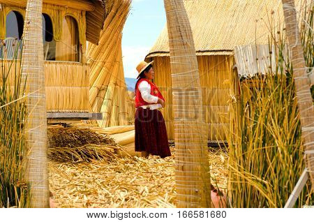 UROS FLOATING ISLANDS PERU - SEPTEMBER 18: Indigenous woman on the Uros Floating Islands Peru on September 18 2014