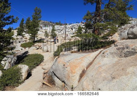 OLMSTED POINT, YOSEMITE NATIONAL PARK - SEP 23: Visitors gather at Overlook Trail on Sep 23, 2015 at Olmsted Point, Yosemite National Park. Olmsted Point is a viewing area off of Tioga Road which offers views into Tenaya Canyon.