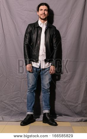 Handsome fashionable guy in full growth. studio photo
