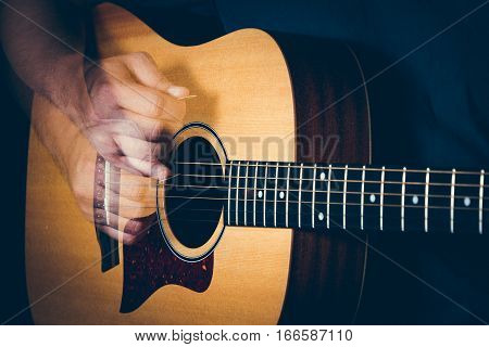 Musician's Hand Is Strumming A Yellow Acoustic Guitar