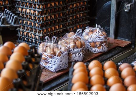 Closeup of many fresh brown eggs in carton tray packeging egg for sale
