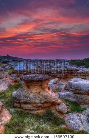 Golden sunrise over the Hoodoo badlands at Writing on Stone Provincial Park and Aisinaipi National Historic Site in Alberta Canada. The area contains a large concentration of First Nation petroglyphs (rock carvings) and pictographs (rock paintings).