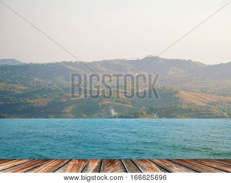 pier wood floor beside sea with blue sky background. summer relaxing time.