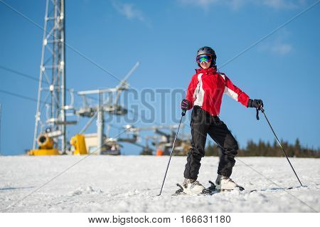 Woman Skier With Ski At Winer Resort In Sunny Day
