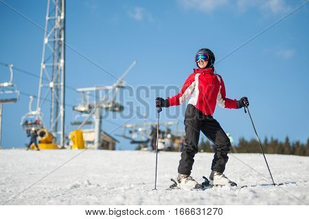 Woman Skier With Ski At Winer Resort In Sunny Day