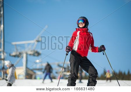 Woman Skier With Ski At Winer Resort In Sunny Day
