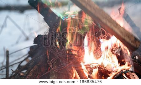 wires on fire. Firing winding insulation of electrical wiring in the fire in the winter woods