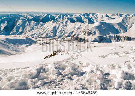 Photo of the View from peak Kudebi on valley Gudauri and Greater Caucasus Mountain Range. Vacation in Georgia. Negative space for text. Extreme sport. Active holiday. Travel concept.