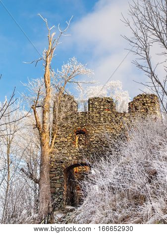 Entrance gate to Medieval castle ruins of Andelska Hora, aka Engelsburg, near Karlovy Vary, Czech Republic, Europe. Sunny and freezy winter day shot.