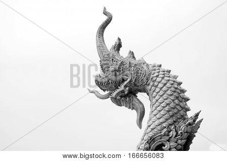 The king of naka statue at thai temple on black and white background