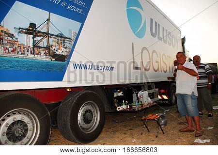 ANKARA, TURKEY - JULY 22, 2011 : Ulusoy Logistics Company's staff beside the semi-trailer truck for Turkish Coffee break in Ankara, Turkey.