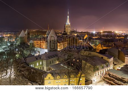 A view of the Tallinn skyline during the winter from the Patkuli Viewing Platform at night. Lots of snow can be seen.