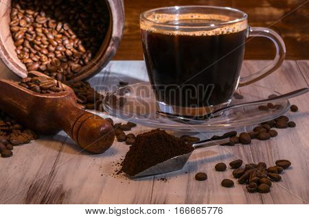 coffee beans, cup of coffee, coffee beans on the wooden table