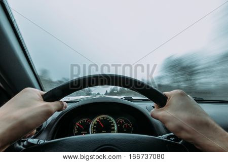 Riding behind the wheel of a car in winter. first-person view