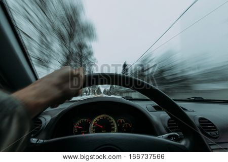 Riding behind the wheel of a car in winter. first-person view
