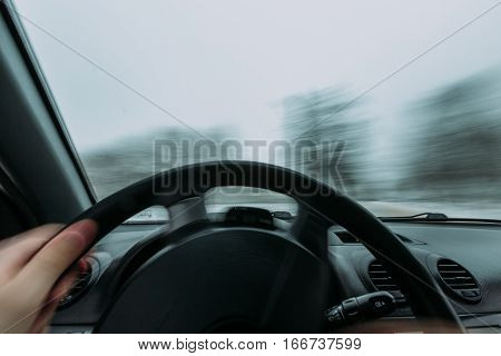 Riding behind the wheel of a car in winter. first-person view