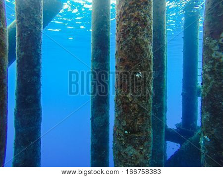 Oil and gas wellhead platform Under water shooting show production gas tubing and platform jacket legs.