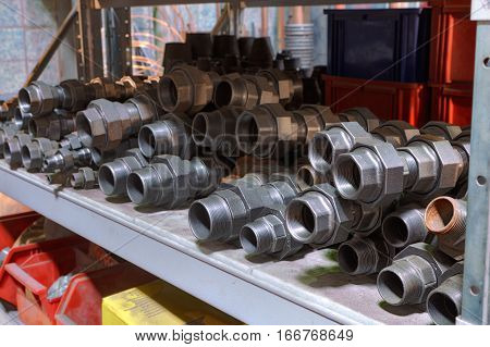 Alloy Steel Threaded Fittings on the shelf in warehouse facilities.