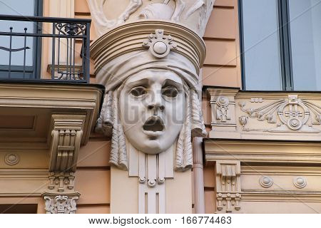 Facade of old building with sculptures of woman heads in Art Nouveau style, Jugendstil. Riga, Latvia.