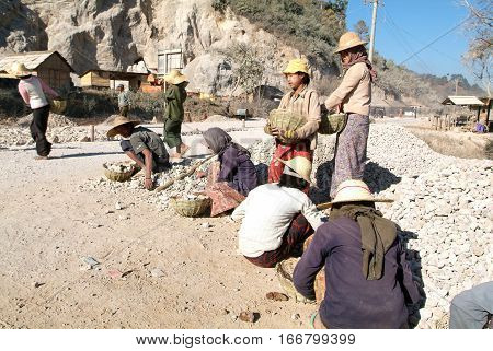 Pindaya Myanmar - 13 January 2010: People transporting stones for road construction near Pindaya on Myanmar
