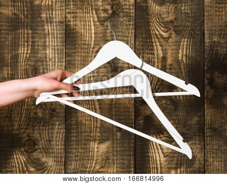 Wood Fashion Hanger In Female Hand In Wardrobe