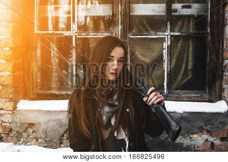 Portrait of brunette girl with a gun. Police undercover