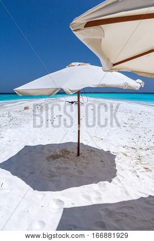 Beautiful tropical Maldives white sand beach with umbrella and blue water for relax.
