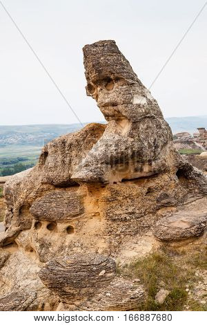 Hoodoo badlands of Writing-on-Stone Provincial Park and Aisinaipi National Historic Site in Alberta Canada. The area contains a large concentration of First Nation petroglyphs (rock carvings) and pictographs (rock paintings). Vertical orientation.