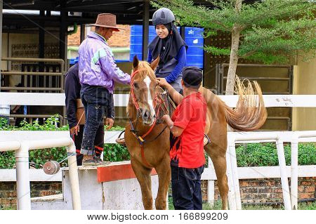 Tuaran,Sabah,Malaysia-Jan 22,2017:Visitor ready to riding a horse in Sabandar Leisure Rides,it is Sabah's attraction for lovers of the Wild West who want to experience horse riding within a paddock