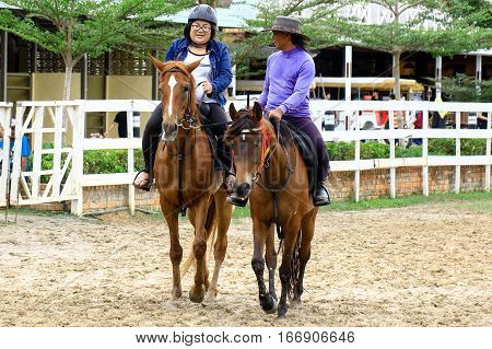Tuaran,Sabah,Malaysia-Jan 22,2017:Visitor riding a horse in Sabandar Leisure Rides cowboy town in Tuaran,Sabah features are a 19th century American lodge,paddocks,riding trails & lots of horses.