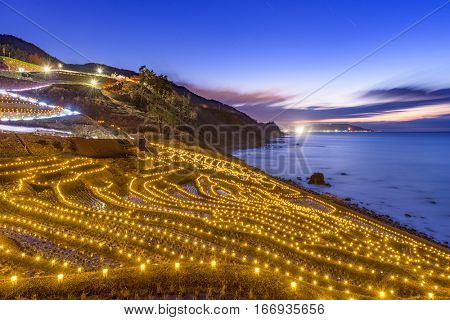 Wajima, Japan at Shiroyone Senmaida rice terraces during a winter light up.