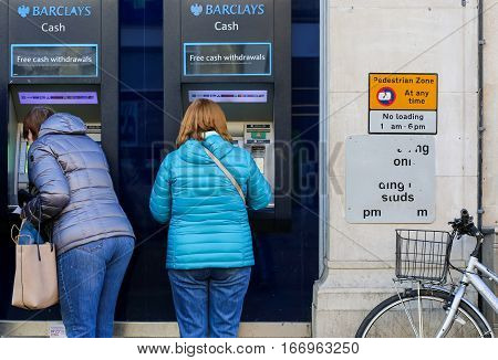 Cornmarket Street Oxford United Kingdom January 22 2017: Customers using a Barclays Bank ATM Bancomats Free Cash Withdrawals at the branch on Cornmarket Street Oxford city centre England