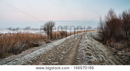 frozen path on the river in winter morning