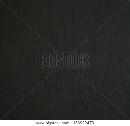 Black paper texture. Pressed paper close-up. Textured paper in black color. Macro photo of black paper blank sheet for graphic design or mockup. Charcoal background image