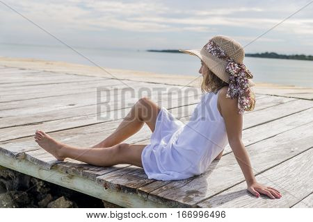 Girl contemplating the horizon from the jetty
