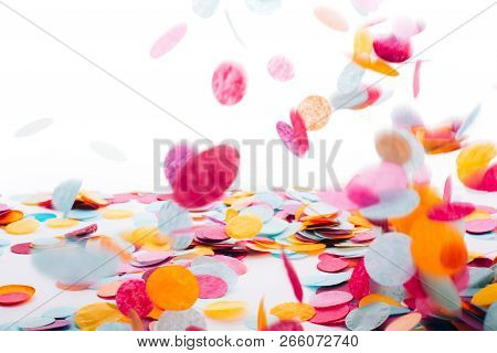 Multicolored Round Confetti Is Flying To The Table. Place For Text. Festive Concept.
