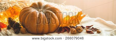 Happy Thanksgiving Day Background, In Home Decorated Pumpkin, Cones, Nuts And Autumn Leaves Garland.