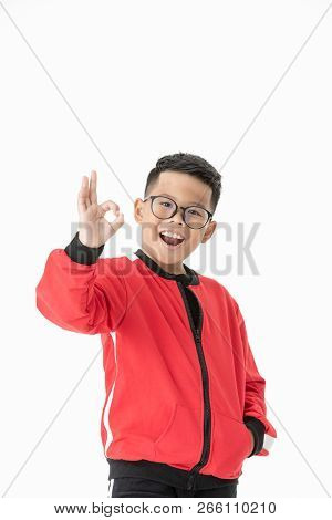 Portrait Asian Cute Boy Showing Okay Gesture Isolated On White Background Studio Shot Close Up.