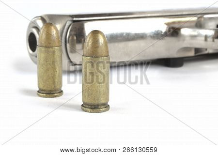Pistol And Ammunition On The White Background.