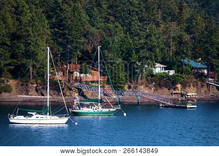 October 12, 2018 In Piers Island, Bc:  Sail Boats Besides Personal Docks Connected To Their Homes Ta