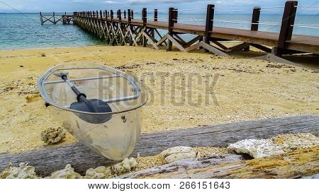 View Of The Transparent Kayak,wooden Pier Or Jetty With Crystal Clear Sea And Sandy Beach In Rusukan