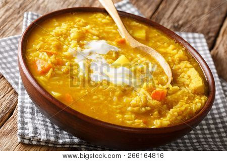Traditional Indian Cuisine Of Colonialists. Homemade Mulligatawny Soup With Lentil, Rice, Cream And