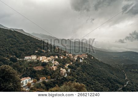 Dark Stormy Skies Over The Mountain Village Of Belgodere In The Balagne Region Of Corsica