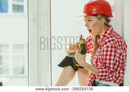 Bored Woman With Helmet Next To The Window