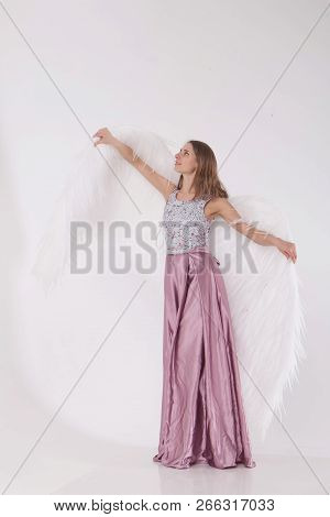 Girl In Pink Dress With Angel Wings On White Background. Angel-woman