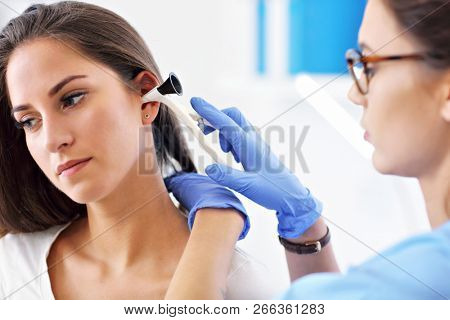 Adult woman having a visit at female laryngologist's office